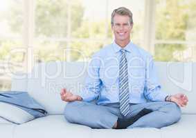 Man Meditating on couch by window
