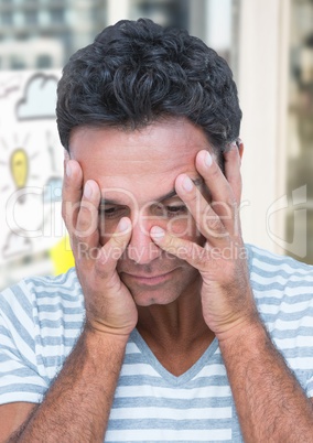 Upset man against lightbulb cloud drawings and windows