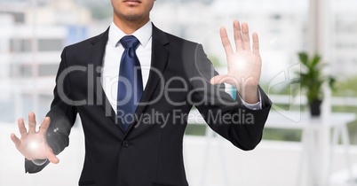 Business man mid section with flares on hands in blurry office