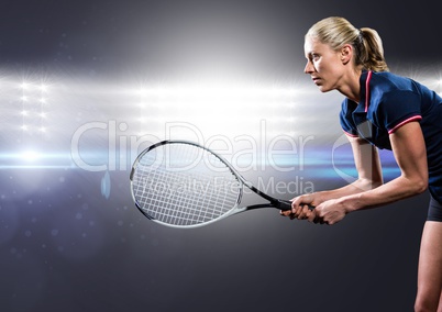 Tennis player with racket outstretched against bright lights