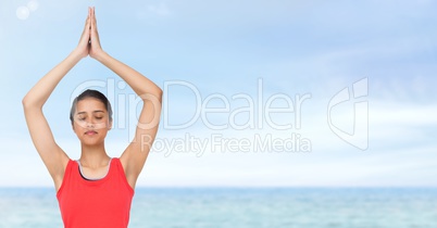 Woman Meditating yoga by sea