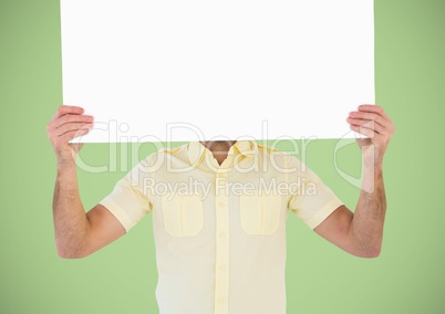 Man with large blank card over face against green background