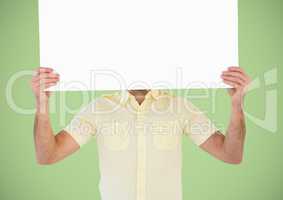 Man with large blank card over face against green background
