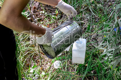 Take samples of water for laboratory testing. The concept - analysis of water purity, environment, ecology.