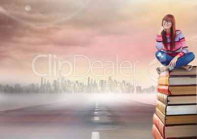 Woman sitting on Books stacked by road to city