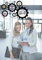 Two business women on tablet with black gear graphics and white overlay