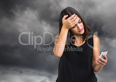 Upset worried woman against dark cloudy sky