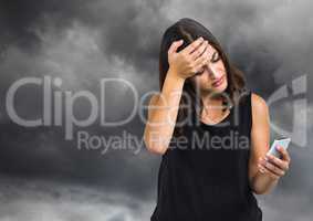 Upset worried woman against dark cloudy sky