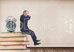 Stressed businessman sitting on Books stacked on shelf with clock