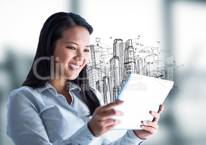 Woman with tablet and sketch of buildings against blurry grey room