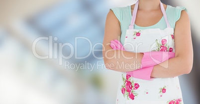 Woman in apron with brushes against blurry window