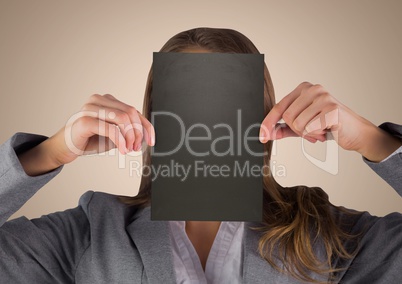 Business woman holding black blank card over face against cream background