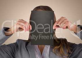 Business woman holding black blank card over face against cream background