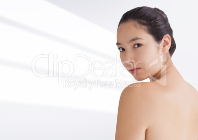 Woman looking over shoulder against white background