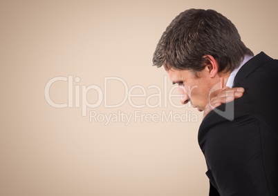 Business man with hand on shoulder against cream background