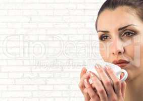 Close up of woman with white cup against white brick wall