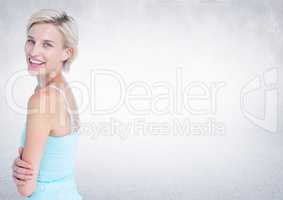 Woman arms folded looking over shoulder against white wall