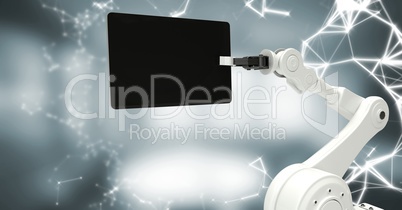 White robot claw with device and white interface against blurry grey room