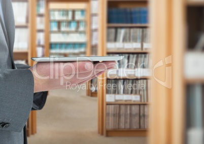 mans hands holding tablet in Library