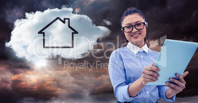 Woman with tablet and cloud with house against stormy sky