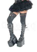 Legs of woman in long black boots.