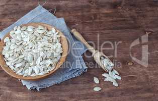pumpkin seeds in a wooden bowl