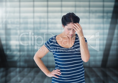 Stressed woman against windows