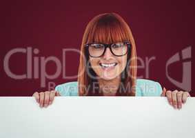 Woman in glasses with large blank card against maroon background