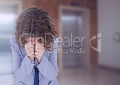 Woman crying in front of elevators