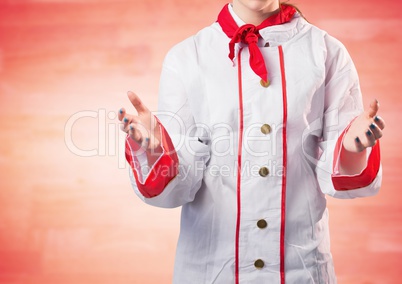 Chef with hands out against blurry red wood panel