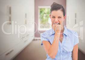 Stressed woman biting hand in room