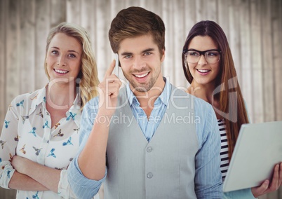 Three people with phone and laptop against blurry wood background