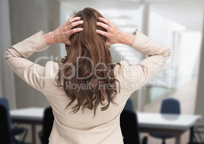 Stressed woman in office meeting room