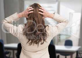 Stressed woman in office meeting room