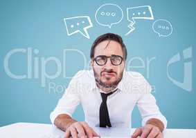 Man at desk with white speech bubbles against blue background