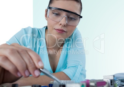 Woman with electronics against green and white background