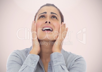 Stressed worried woman looking up with pink background