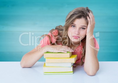 Woman with books at desk against blurry blue wood panel