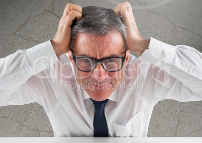 Stressed man against cracking concrete background