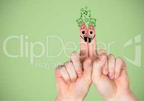 Hands with patrick's day faces drawn on against green background