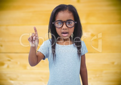Girl in glasses against yellow wood panel