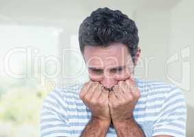Worried stressed man against bright background