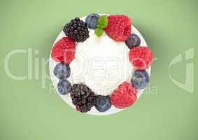 berries fruit with cream on plate against green background