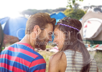 Hippie couple in campsite with flare