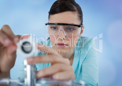 Close up of woman with electronics against blurry blue background