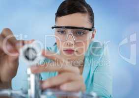 Close up of woman with electronics against blurry blue background