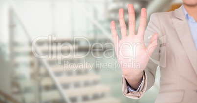 Business woman mid section with flare on palm against blurry stairs