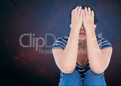 Sad woman with hands over head against blue background