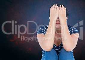 Sad woman with hands over head against blue background