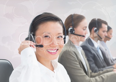 Travel agents with headsets against white map